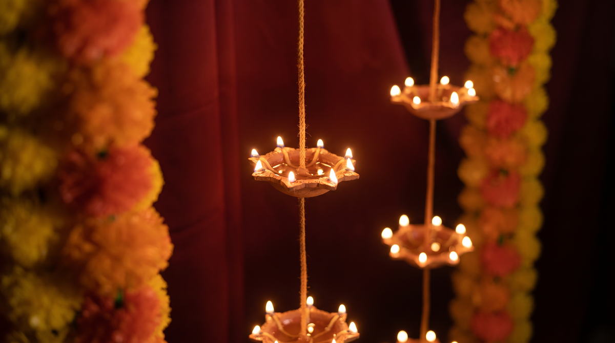 Ganpati close-up styling of the Pair of 7 Vertical Diyas, editorial campaign shot