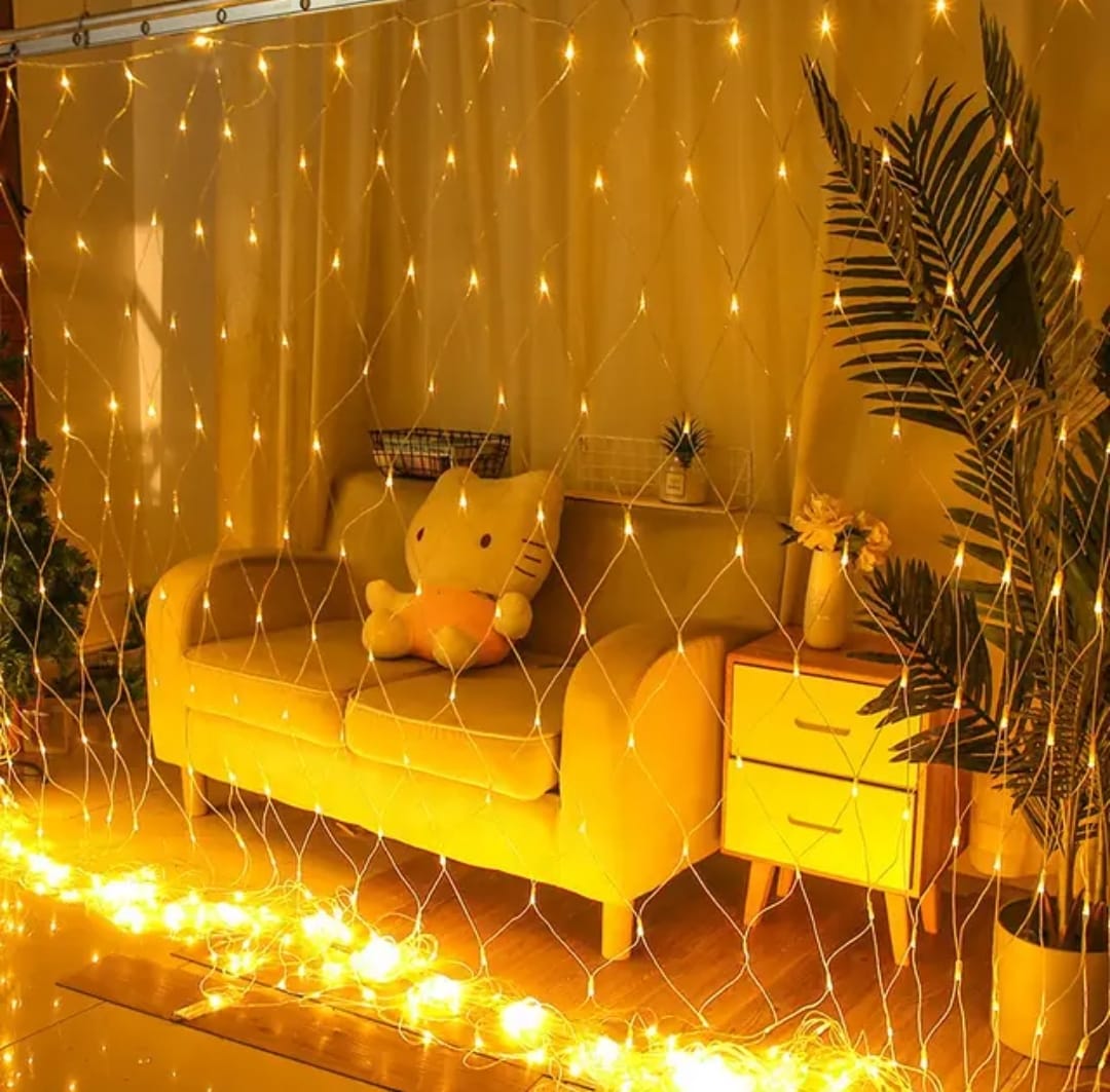 LED mesh net curtain lights draped over garden shrubs