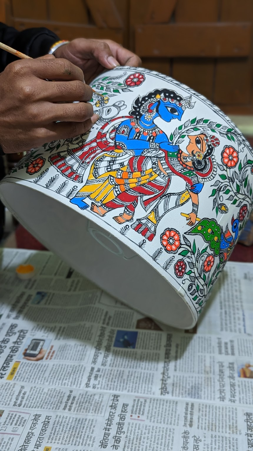 Artisan hand-painting a Madhubani lampshade