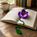 Purple Orchid crochet bookmark placed in an open book