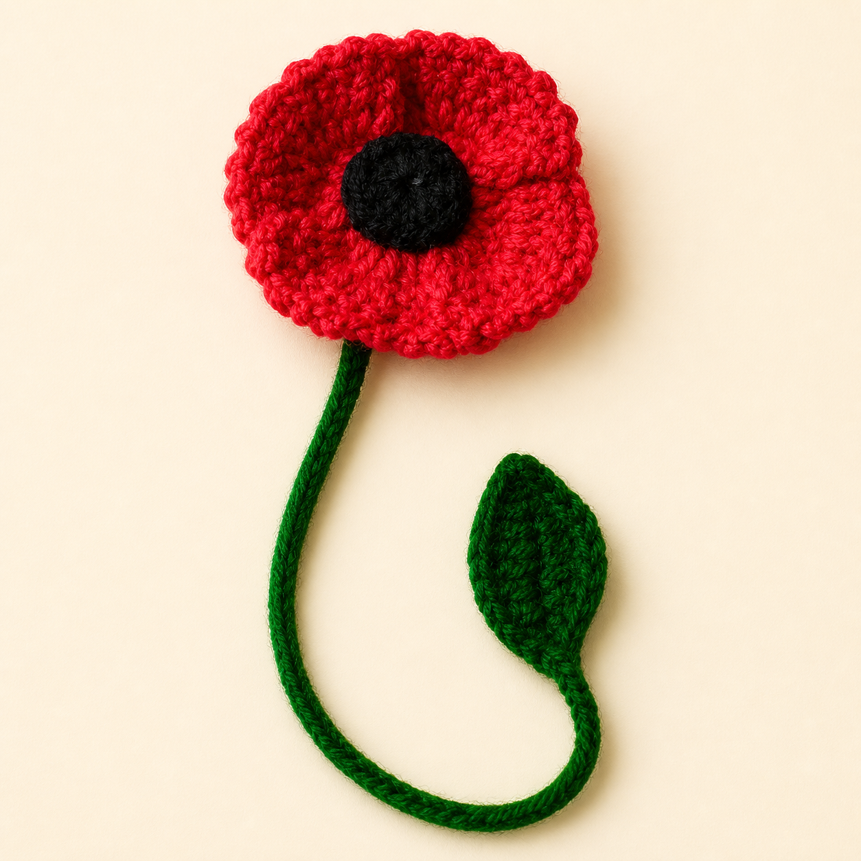 Red Poppy handmade crochet flower bookmark, studio photo