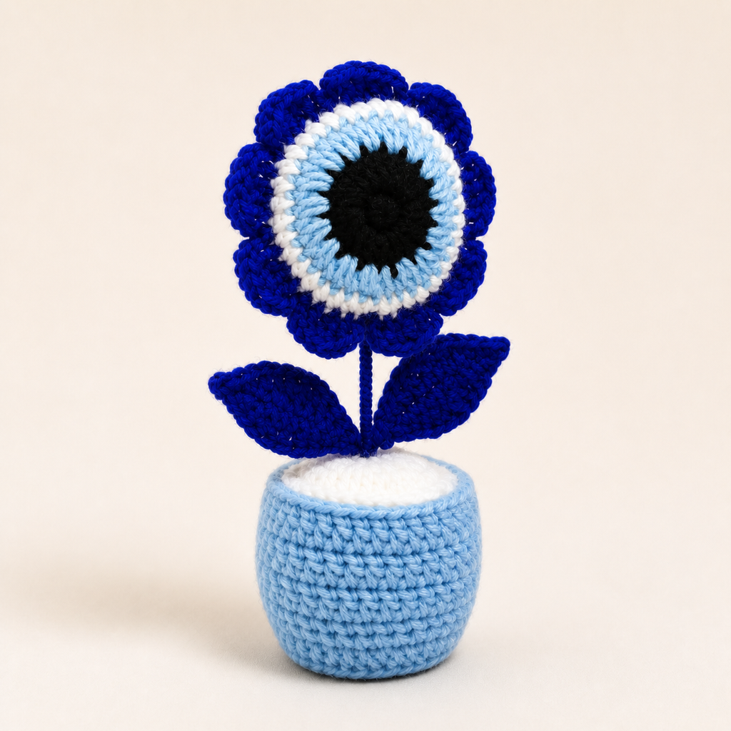 Handmade blue crochet evil eye flower in a light blue pot