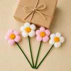 Crochet puff flower set of four displayed beside a gift box