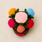 Top view of colourful crochet roses in yellow, blue, red, pink, light pink and peach