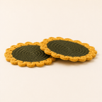 Side view showing the thickness of two crochet sunflower coasters