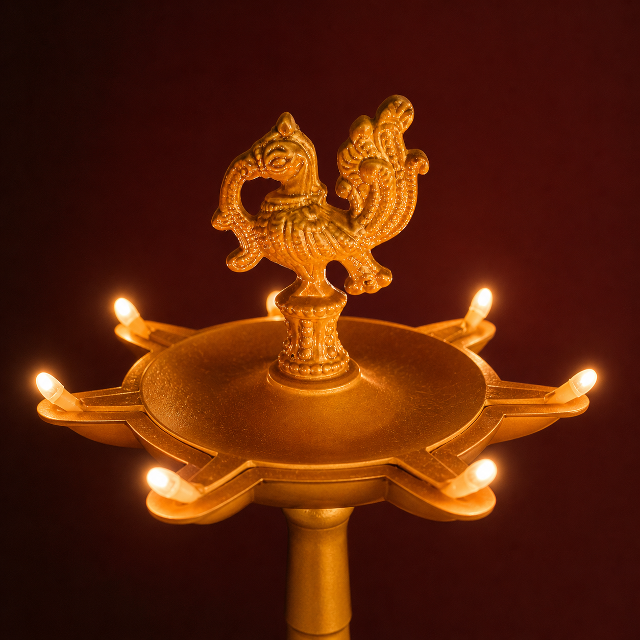Close-up of the peacock finial and electric diya lights
