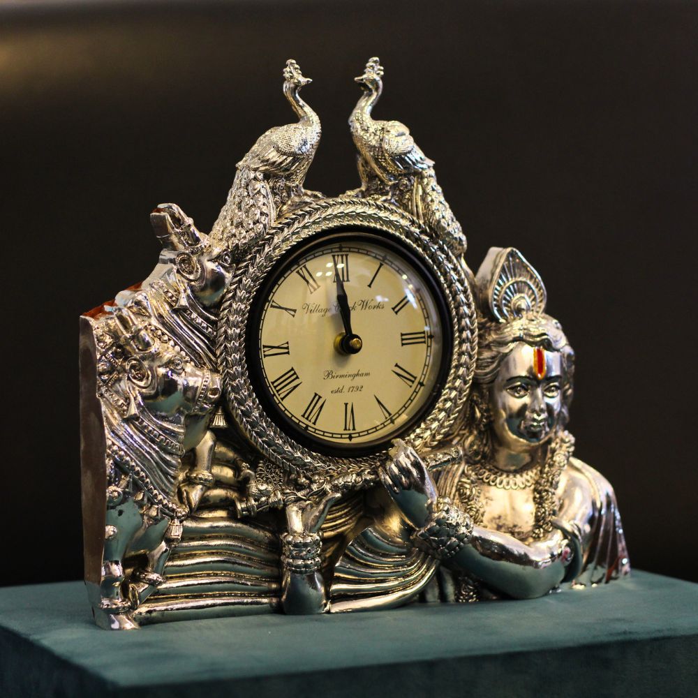 Krishna Twin Peacock Table Clock — Silver and gold tone on a teal-green base