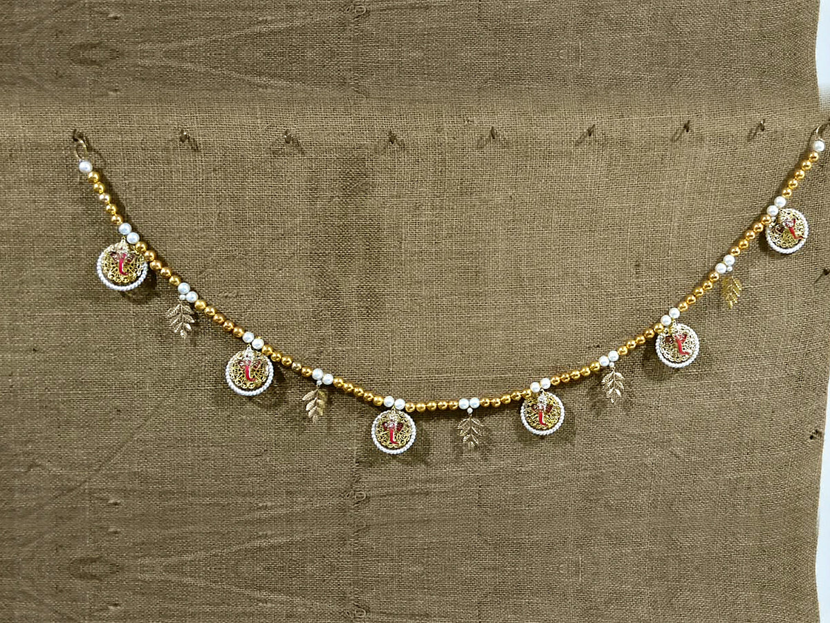 Ganesha Pearl Toran hung on a wall – full view
