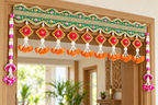 Green embroidered toran with orange roses and pink side hangings in a modern home