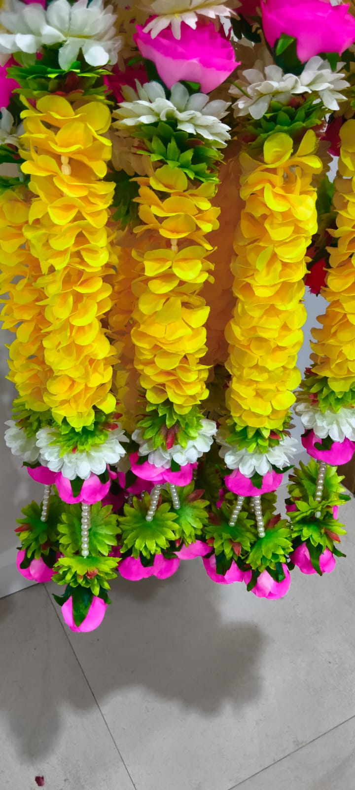 Original close-up showing artificial flowers, green accents and pearl details