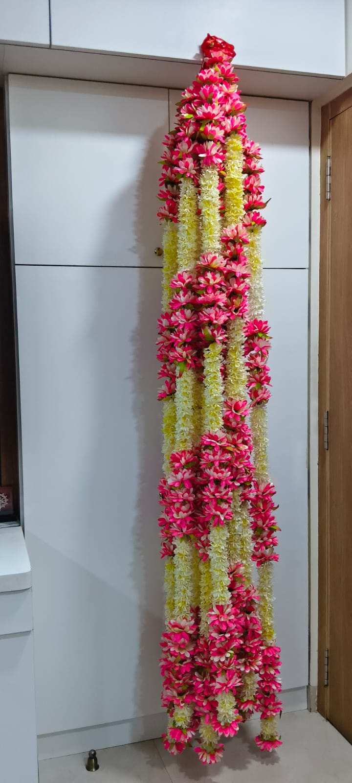 Original full-length view of pink and cream artificial flower garland