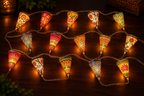 15 hand-painted leather cone fairy lights glowing on a dark table