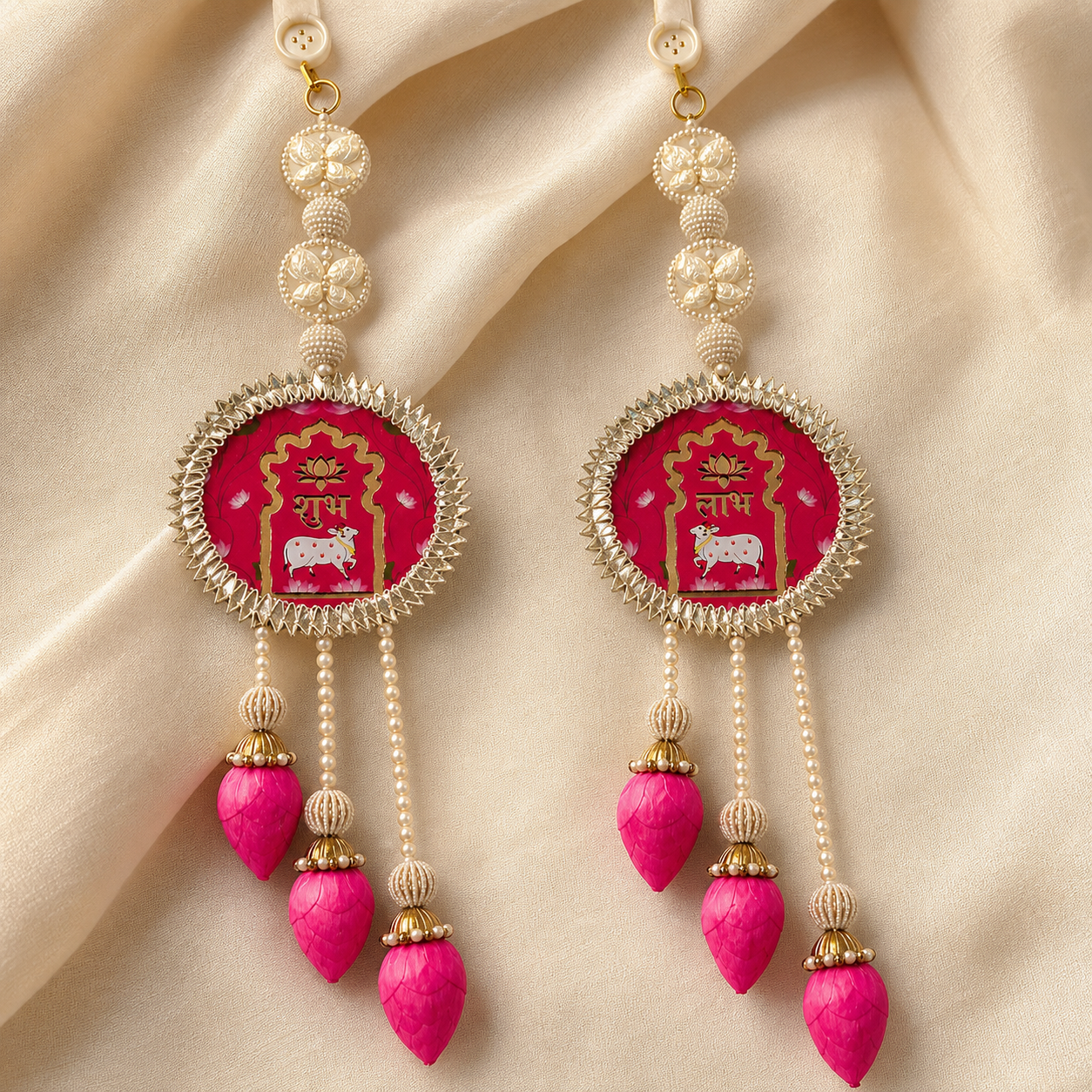 Lotus Butterfly Shubh Labh pair with pink lotus tassels on fabric