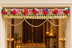 Multicolour rose toran with gold bead garland at a festive entrance