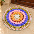 Lavender and peach rose rangoli with pink pom-poms on an entrance floor