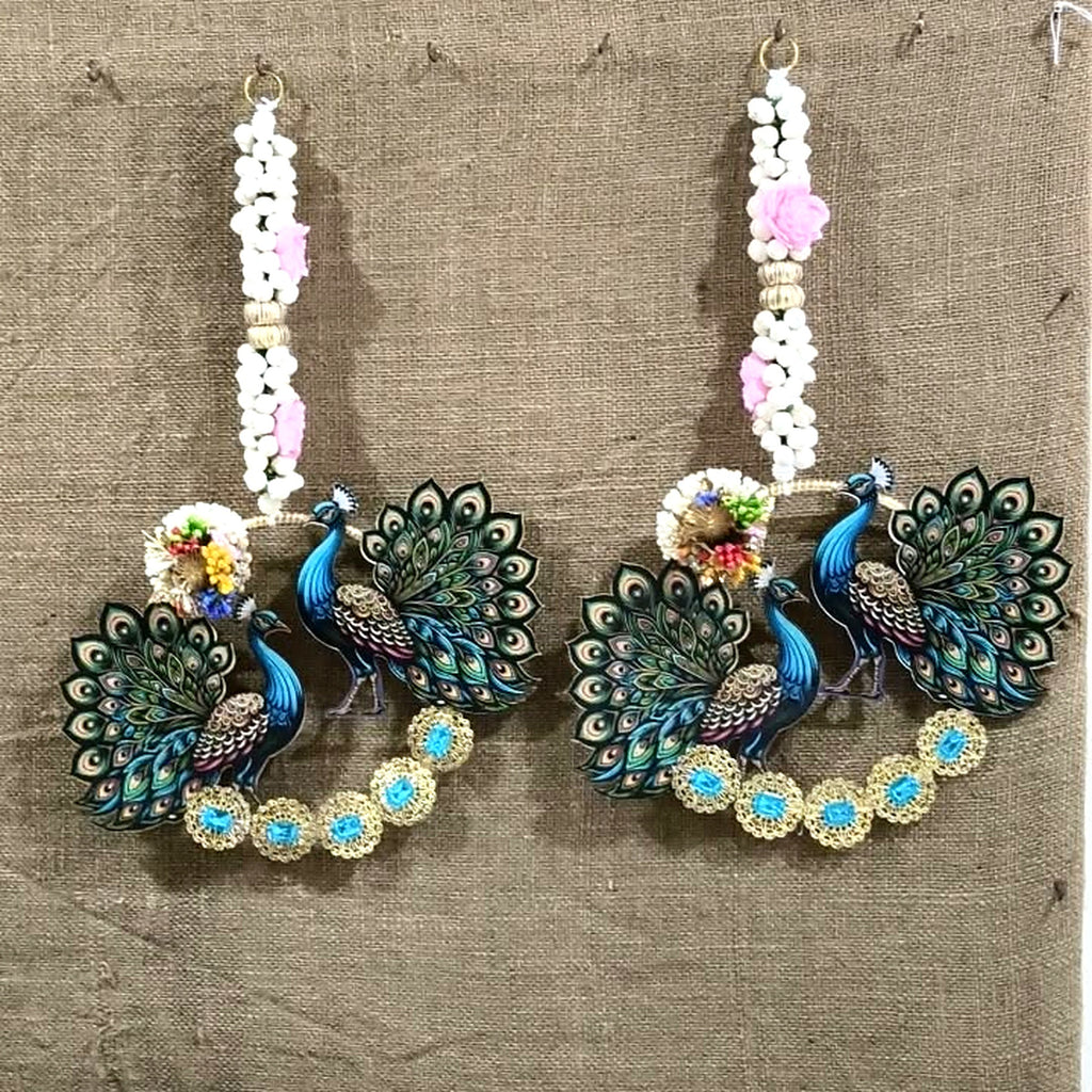 Peacock wall hanging pair hung side by side on a wall
