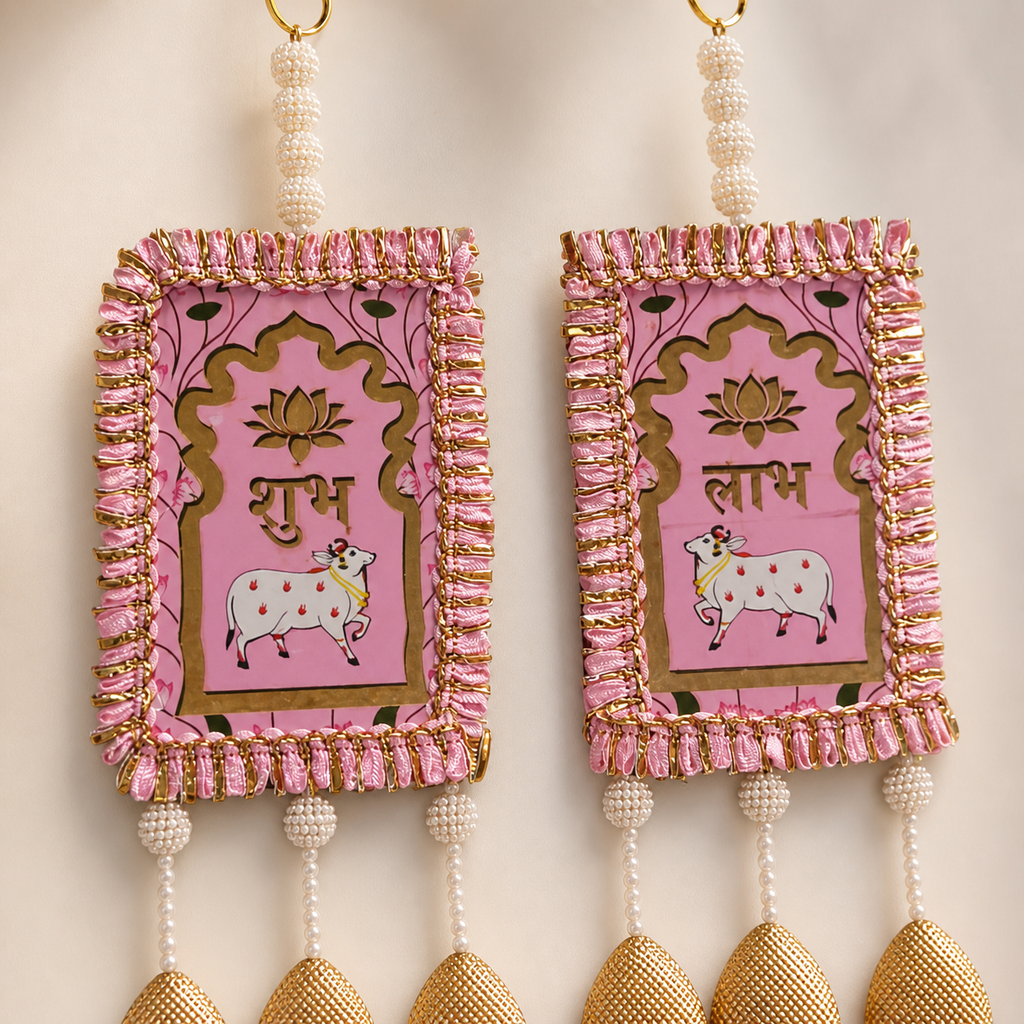 Close-up of the pink Shubh and Labh panels with traditional cow and lotus motifs