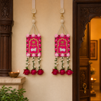 Pink Shubh Labh door hanging pair displayed at an entrance