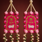 Close-up of pink Shubh Labh panels with lotus and cow motifs
