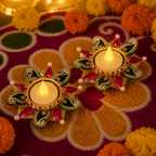 Purple stone tea-light holder pair displayed with festive rangoli