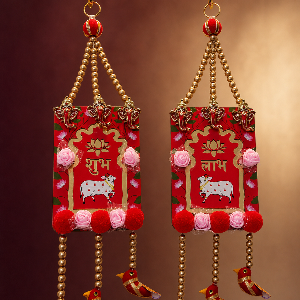 Close-up of red Shubh Labh panels with Ganesha charms, roses and gold beads
