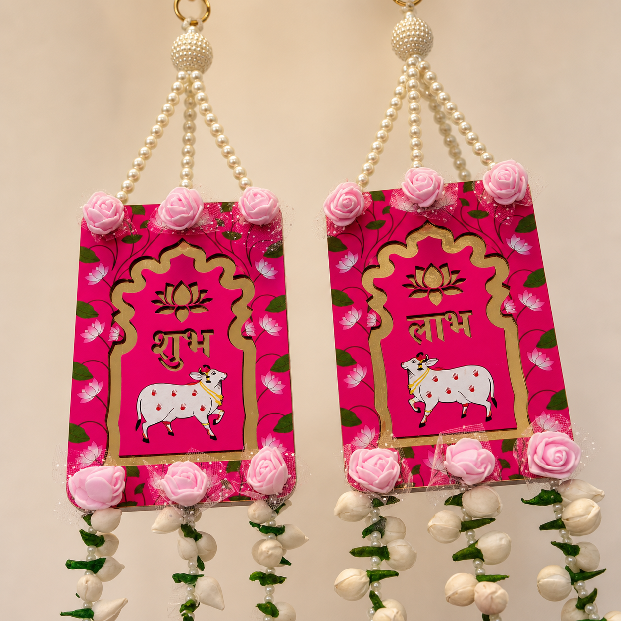 Close-up of red Shubh and Labh panels with lotus, cow motifs and pink rose accents