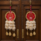 Round Shubh Labh floral hanging pair displayed on a carved wooden entrance door
