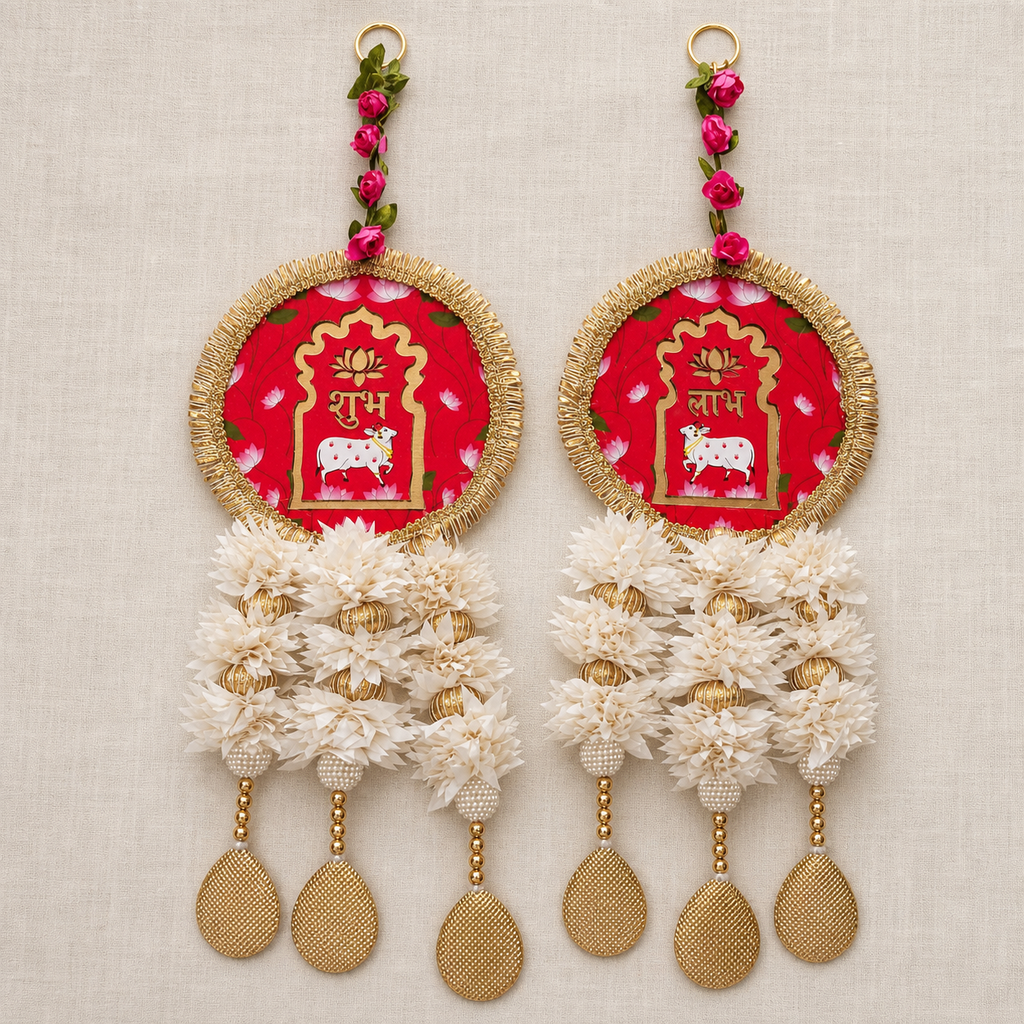 Full view of the red and white floral Shubh Labh hanging pair on a neutral fabric background