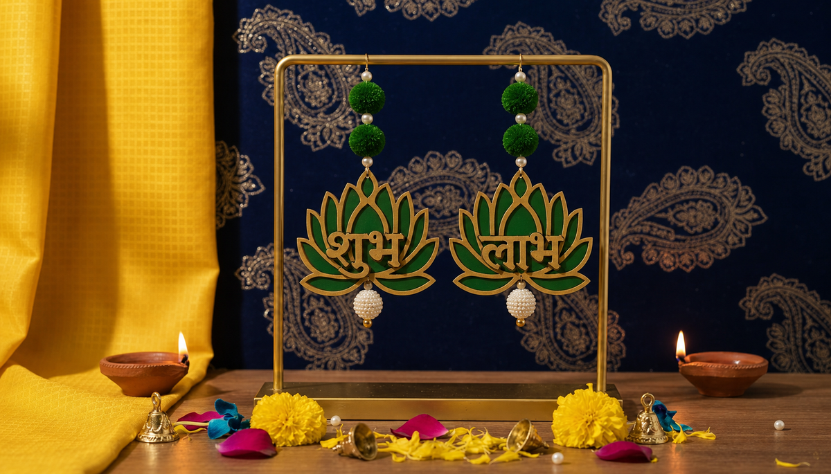 Green and gold Shubh Labh lotus door hanging pair styled with diyas and marigolds