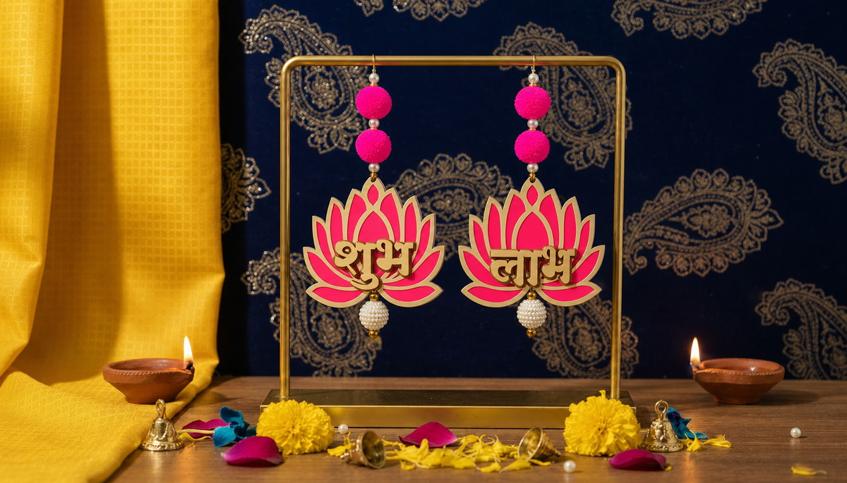 Pink and gold Shubh Labh lotus door hanging pair styled with diyas and marigolds