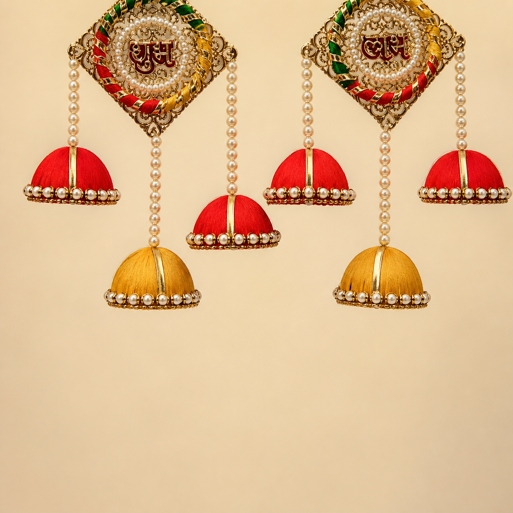 Detailed view of pearl strands and red and yellow silk jhumkas on the Shubh Labh hanging pair