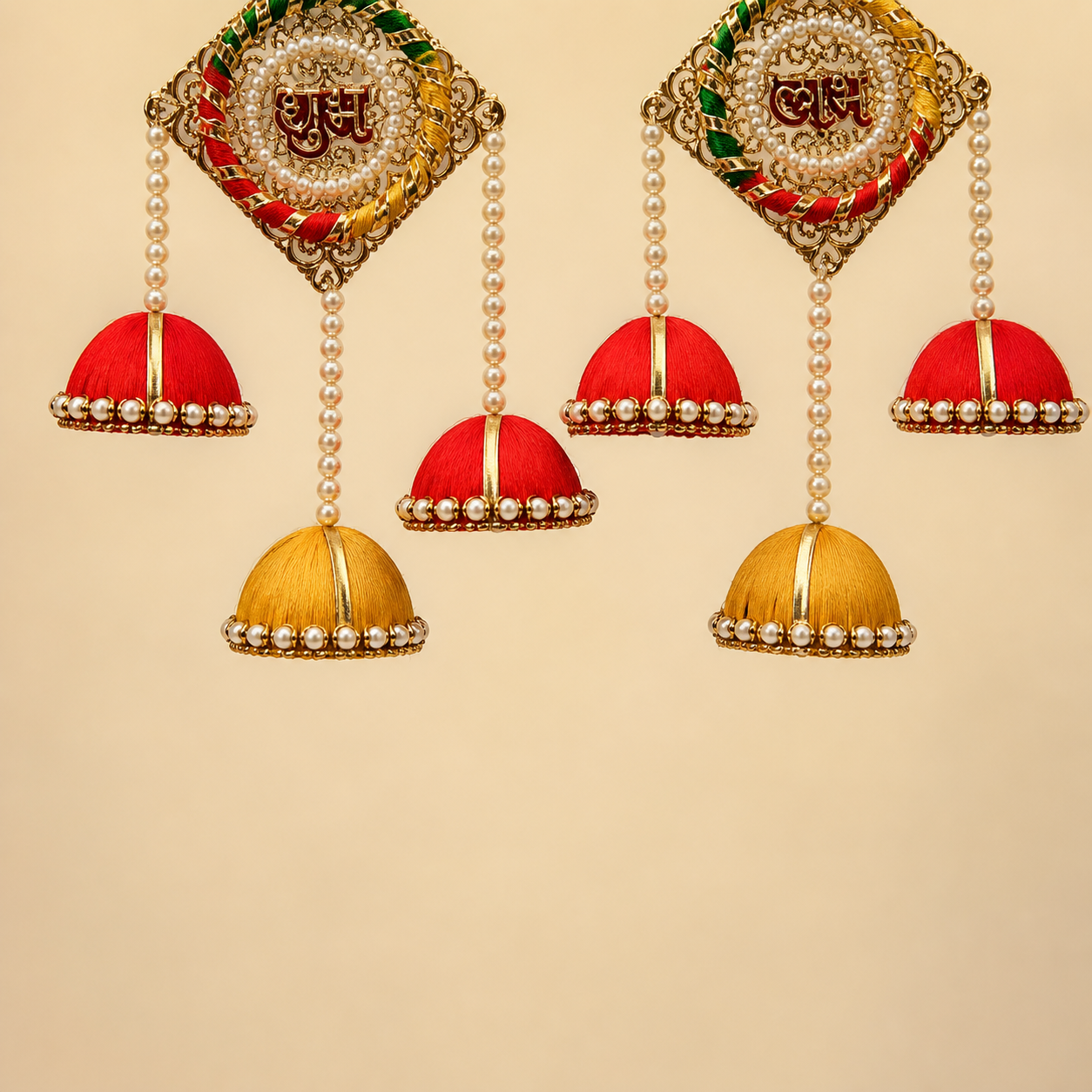 Detailed view of pearl strands and red and yellow silk jhumkas on the Shubh Labh hanging pair