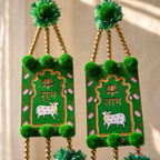 Close-up of Shubh and Labh central panels with lotus and cow motifs