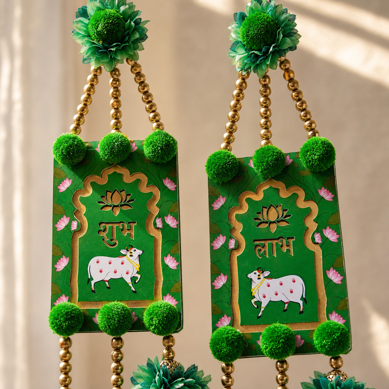 Close-up of Shubh and Labh central panels with lotus and cow motifs