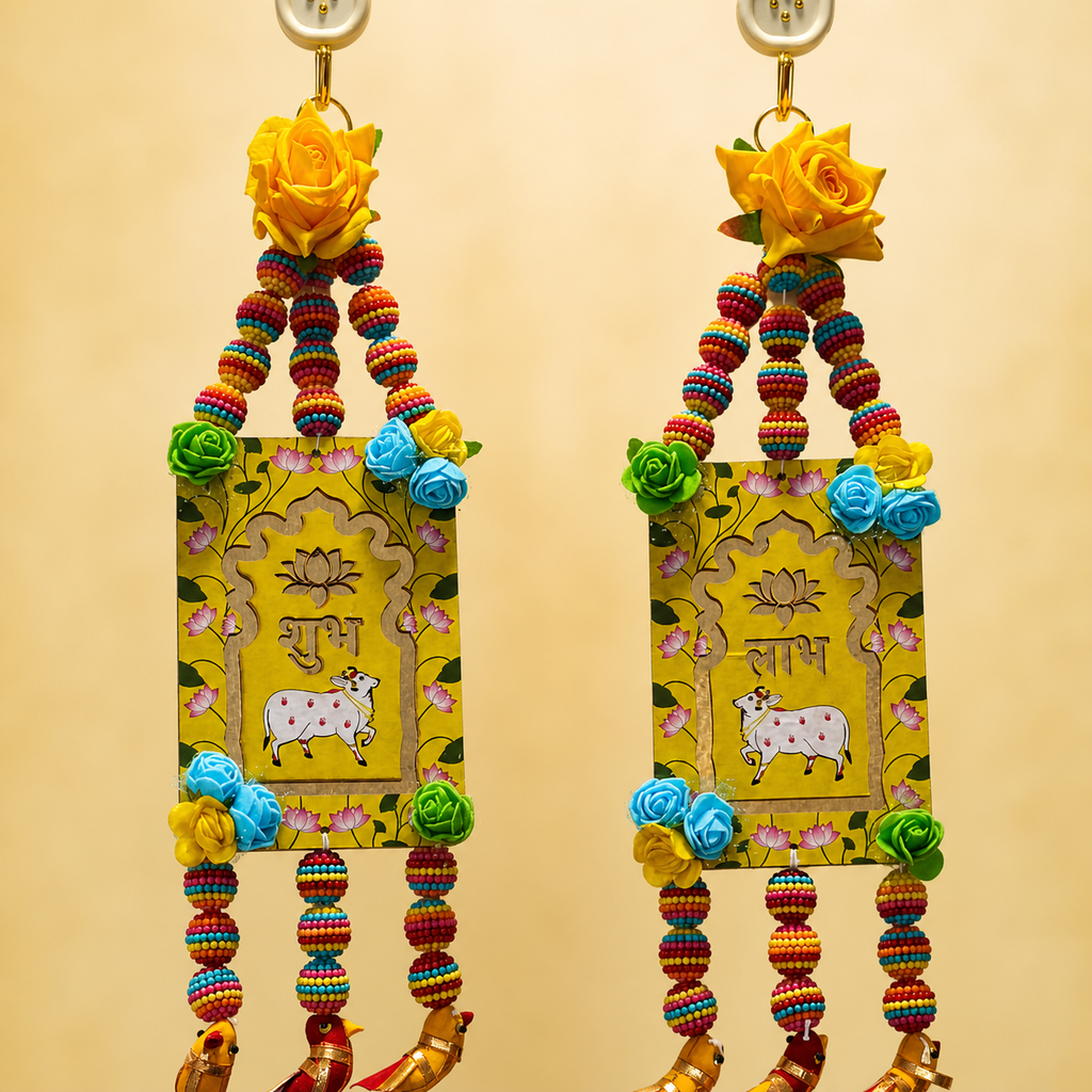 Close-up of yellow Shubh Labh panels with floral accents and beaded strands
